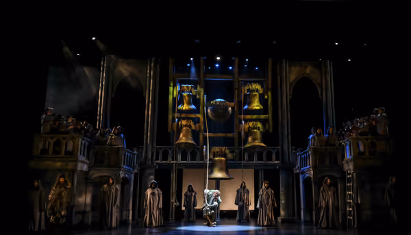 David  Burnham  (center)  as  Quasimodo  and  the  company. Photo