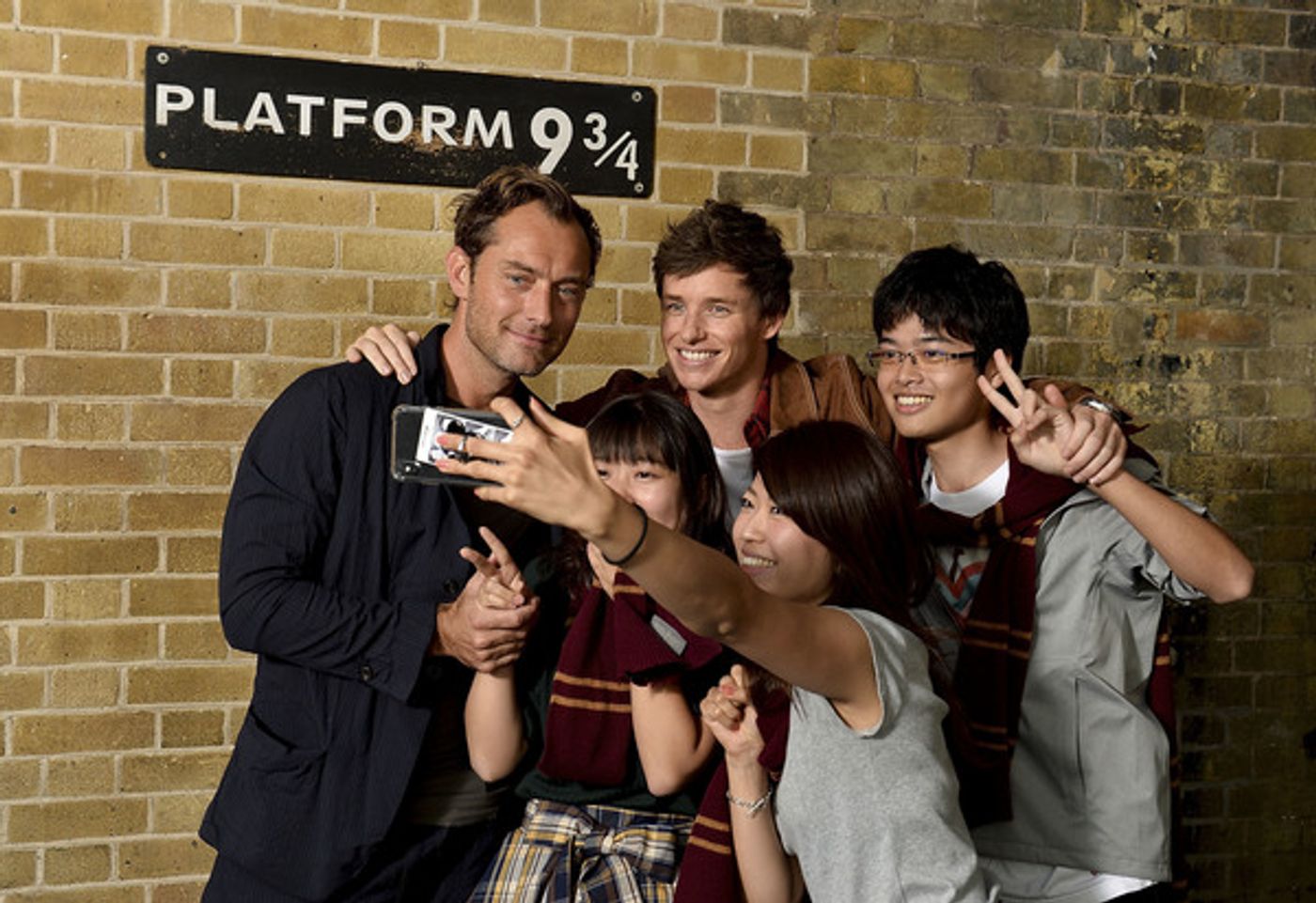 Photo Coverage: See Eddie Redmayne and Jude Law at King's Cross Station for 'Back to Hogwarts' Day  Image