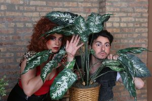 Roxanne Nurdiger (Sydney Genco) and Zachary Slade (David Lipschutz) find some alone time in the shrubbery in a publicity image for Hell in a Handbag Productions’ comedy THE ARTIFICIAL JUNGLE. @ BroadwayWorld Roxanne Nurdiger (Sydney Genco) and Zachary Slade (David Lipschutz) find some alone t Photo
