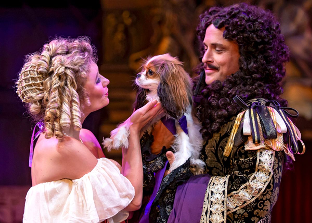 Nell Gwynn (Scarlett Strallen) and King Charles II (Timothy Edward Kane) embrace the royal spaniel, Oliver Cromwell (Bentley) in Chicago Shakespeareâ€™s North American premiere production of Nell Gwynn at 