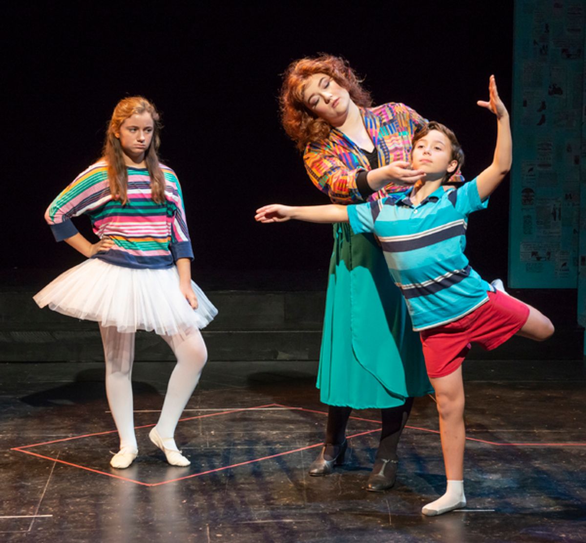 (left to right) Tatum Lowell as Debbie, Rachel Meyer as Mrs. Wilkinson, and Uzay Hasanusta as Billy (select performances) in the Des Moines Community Playhouseâ€™s production of Billy Elliot The Musical at 