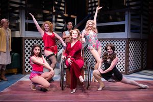 Dyan McBride (center) as Miss Mona with the ladies of the Chicken Ranch (L to R: Madison Genovese, Yuliya Edelnant, Andrea Dennison-Laufer, Doris Bumpus, Anne Norland, Brittney Monroe) .Photo: Ben Krantz Studio.
@ BroadwayWorld Dyan McBride (center) as Miss Mona with the ladies of the Chicken Ranch (L to R: Madi Photo