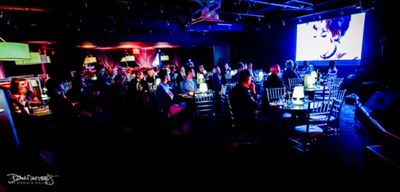 The audience enjoys clips from Barbara Harris' film work. Photo