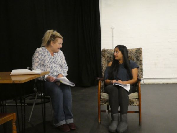 Kerry Joy Stewart and Serin Ibrahim in rehearsal for HERE by Michael Frayn, playing a Photo