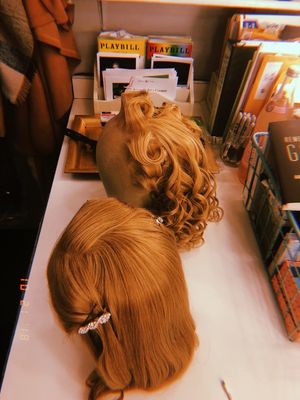 â€"Gold hair with a gentle curl…â€
Our fabulous Hair Supervisor Mary Kay Yezerski delivers these two beauties right before half hour. Fun fact, I actually have two bubble wigs (the curly one) and each wig is custom made for every actor’s particular @ BroadwayWorld â€"Gold hair with a gentle curl…â€
Our fabulous Hair Supervisor Mary Photo