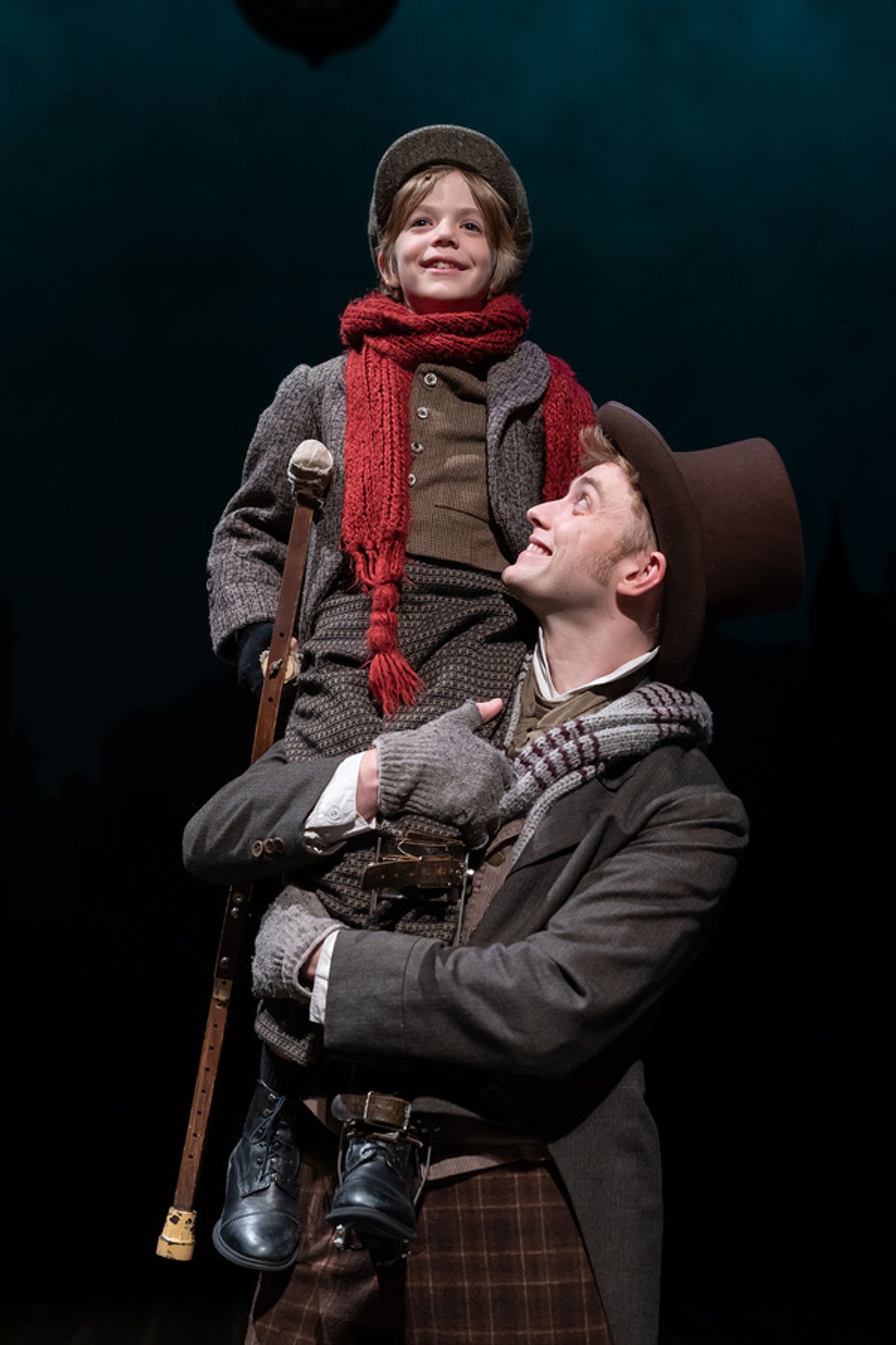 Aidan Fuller as Tiny Tim and Gregory Maheu as Bob Cratchi at 