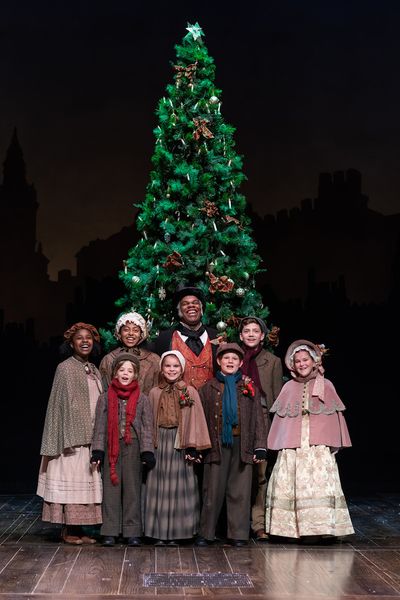 Craig Wallace as Ebenezer Scrooge and the young cast of the 2018 Fordâ€™s Theatr Photo