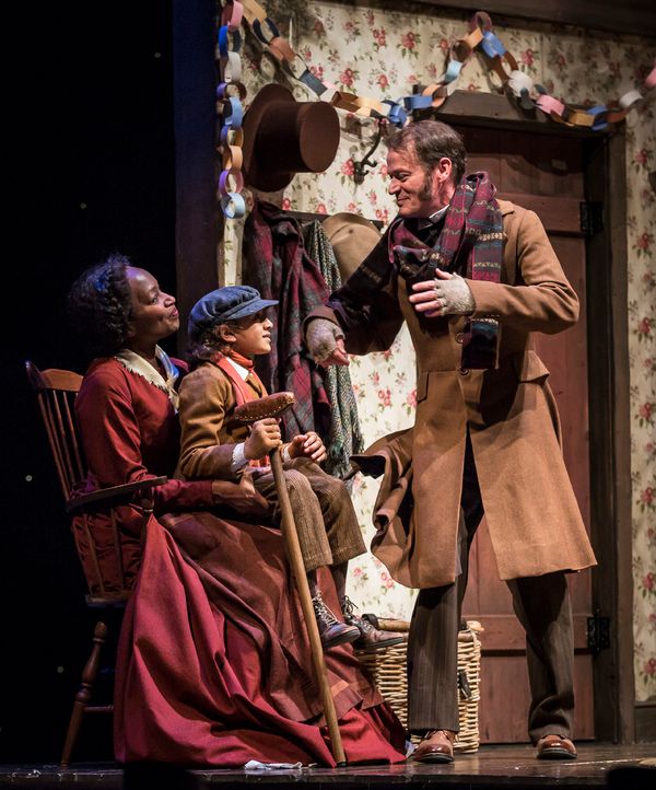Lily Mojekwu (Mrs. Cratchit), Paris Strickland (Tiny Tim Cratchit) Photo