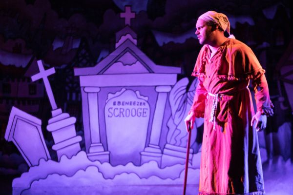 Scrooge (Eric Fletcher) at his grave

Photo: Martin Harris Photo