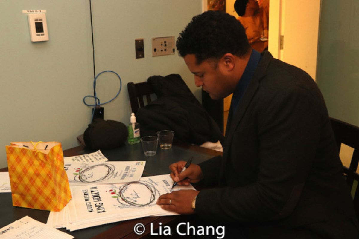 Brandon J. Dirden signs posters at 