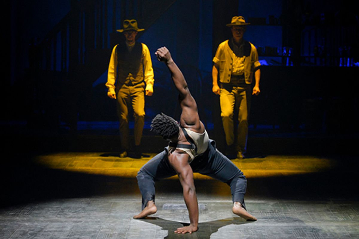  Jacobi Hall (Ensemble); (background, l to r) Garrett Colemen (Ensemble) and Jason Oremus (Ensemble) at 