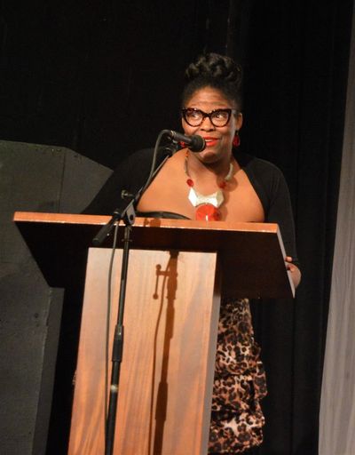 Jennifer Whitcomb-Oliva presents the award for Outstanding Musical Direction. Photo