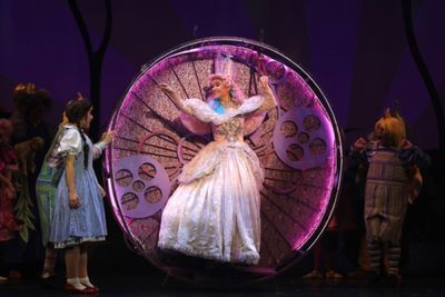 Glinda (Kat Walker Hill) flies into welcome Dorothy to Munchkinland in The Wizard of  Photo