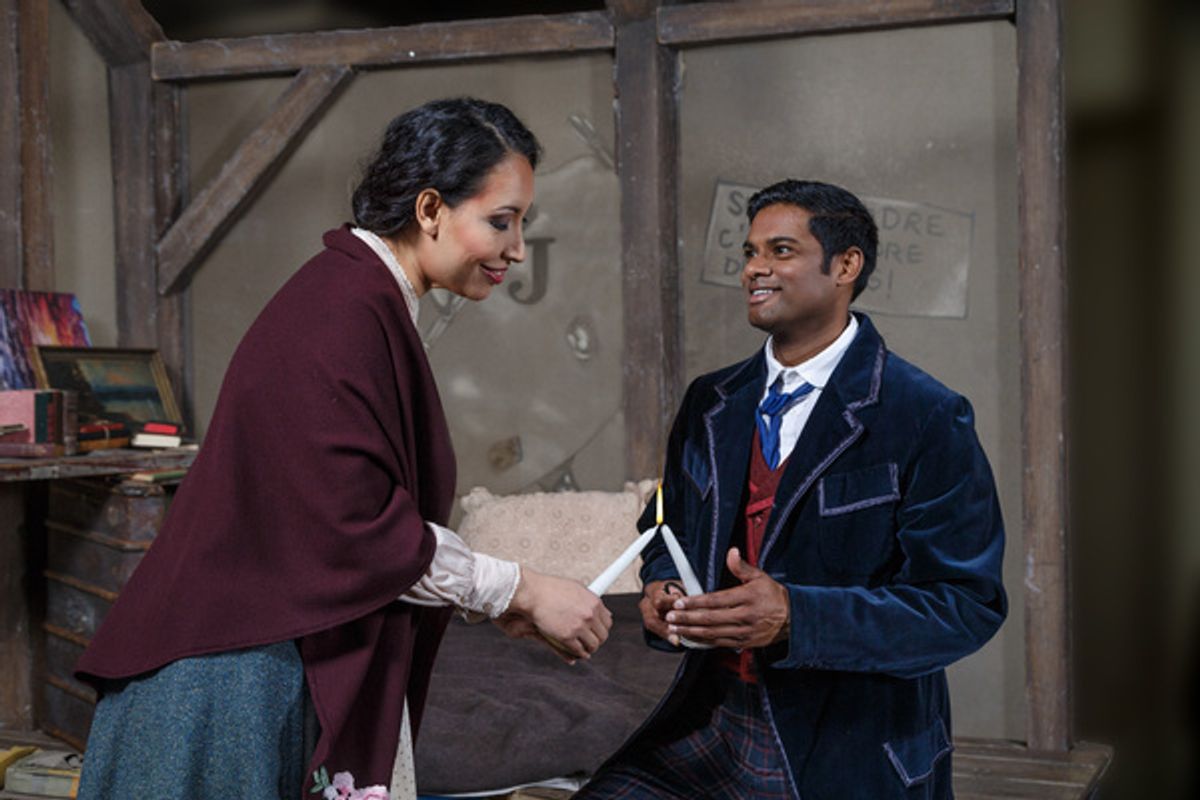 Rodolfo (Sean Panikkar) offers MimÃ¬ (Nicole Cabell) a light in his garret at 