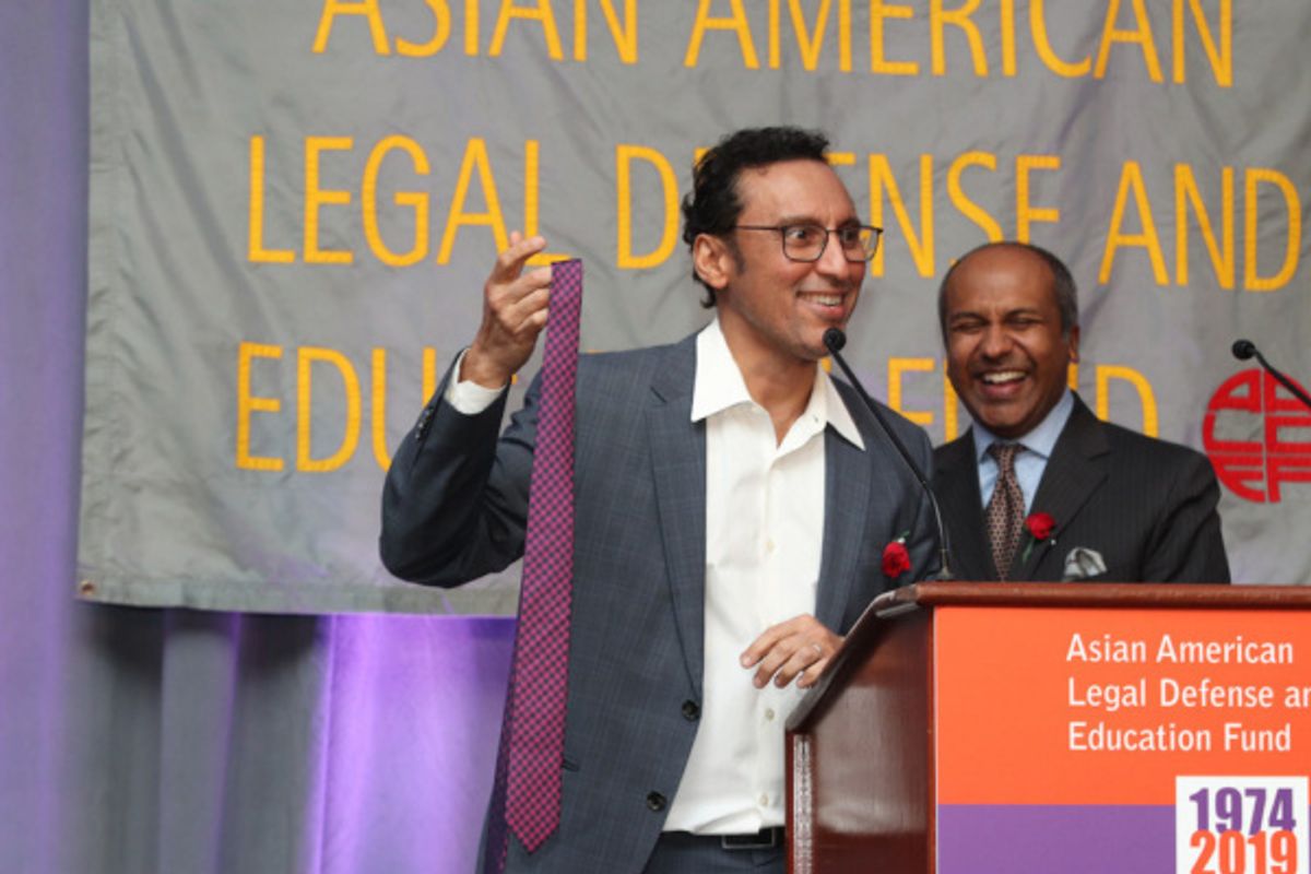 Aasif Mandvi donates his tie for AALDEF''s live auction; with emcee Sree Sreenivasan at 