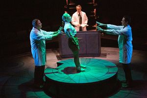 Michael Pemberton as Lab Tech, Morgan Hallett as Jerrie Cobb, Matthew Boston as Dr. Randy Lovelace, and Peter Rini as Lab Tech @ BroadwayWorld Michael Pemberton as Lab Tech, Morgan Hallett as Jerrie Cobb, Matthew Boston as Dr. R Photo