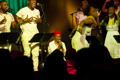 Tshidi Manye (center) performs with WiLDFLOWER cast
 Photo