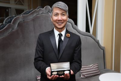 Gold Mountain creator Jason Ma was presented with one of only five sets of commemorat Photo