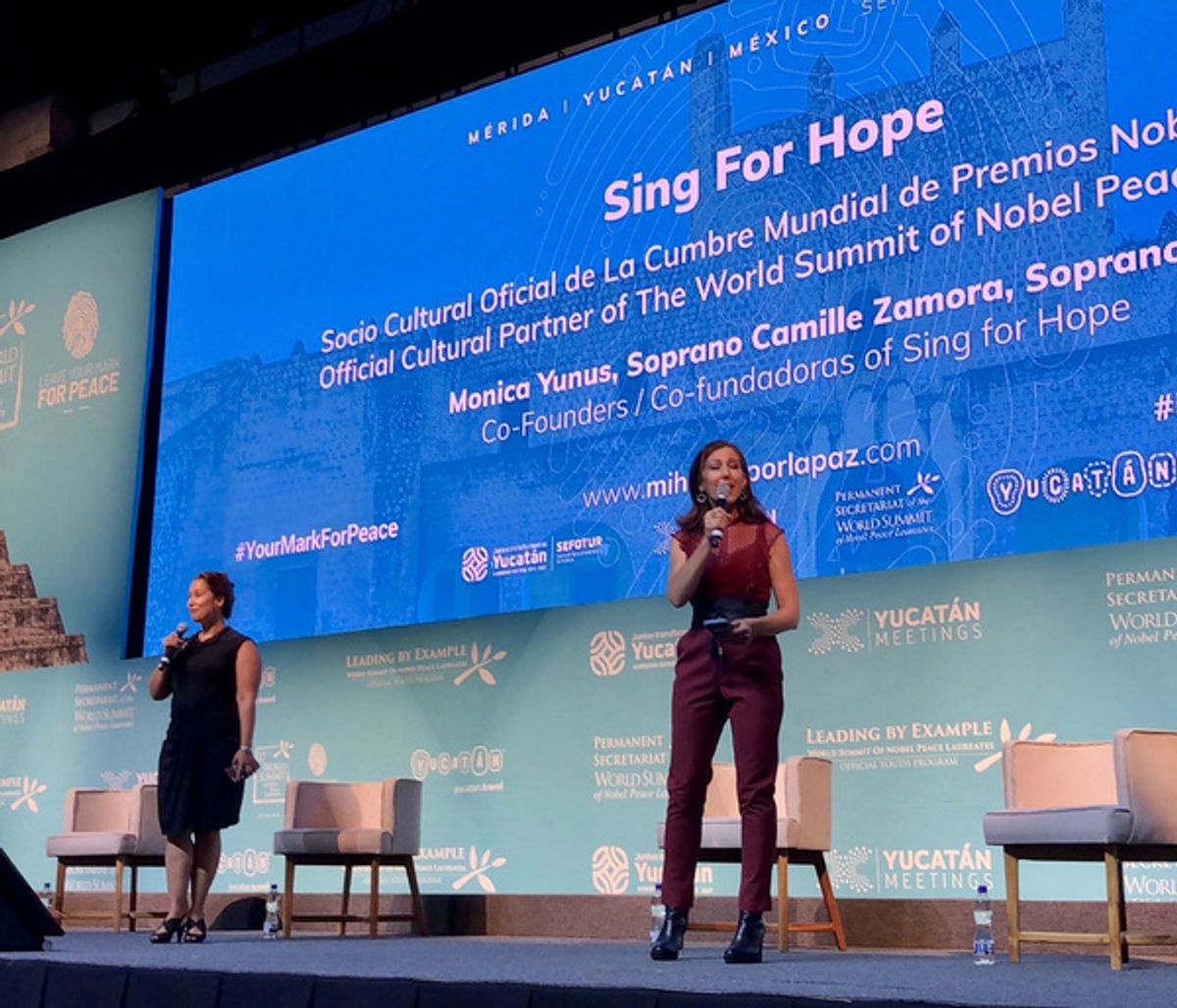 Sing for Hope Co-Founders Monica Yunus and Camille Zamora on the Nobel Peace Summit stage at 