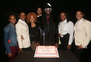 Otis Williams poses with the female cast members  Photo