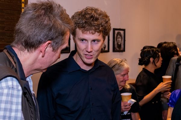 Jonathan Fadner (Composer/Writer) speaks with a guest. (Dusty Rhoades)   Photo