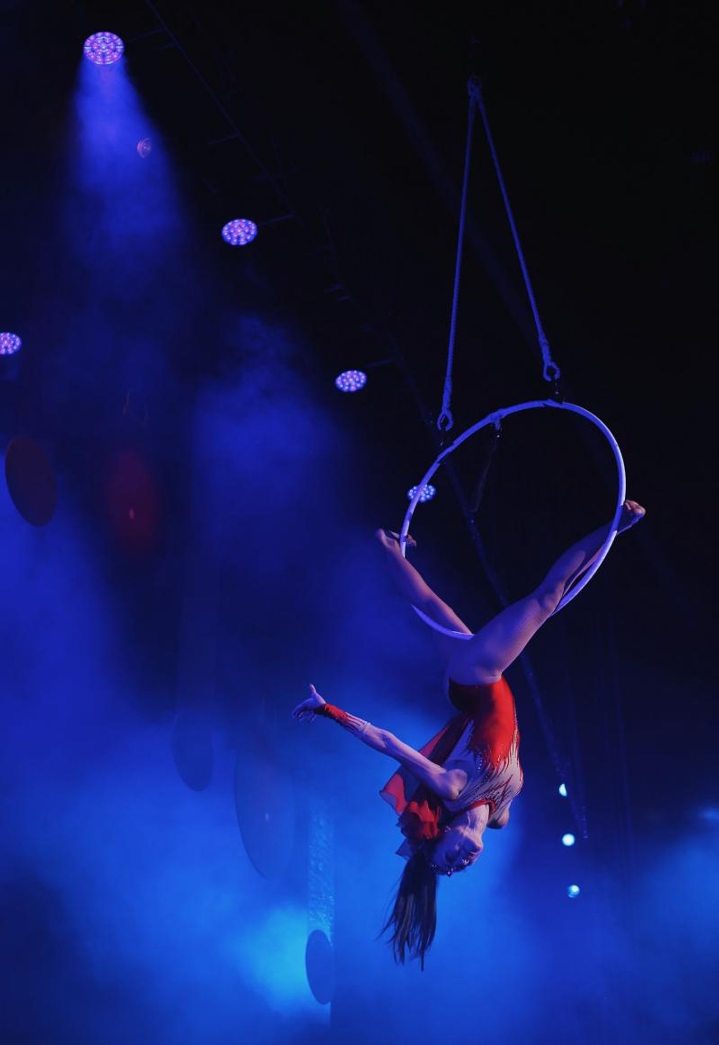 Woman performing on a ring suspended above the stage