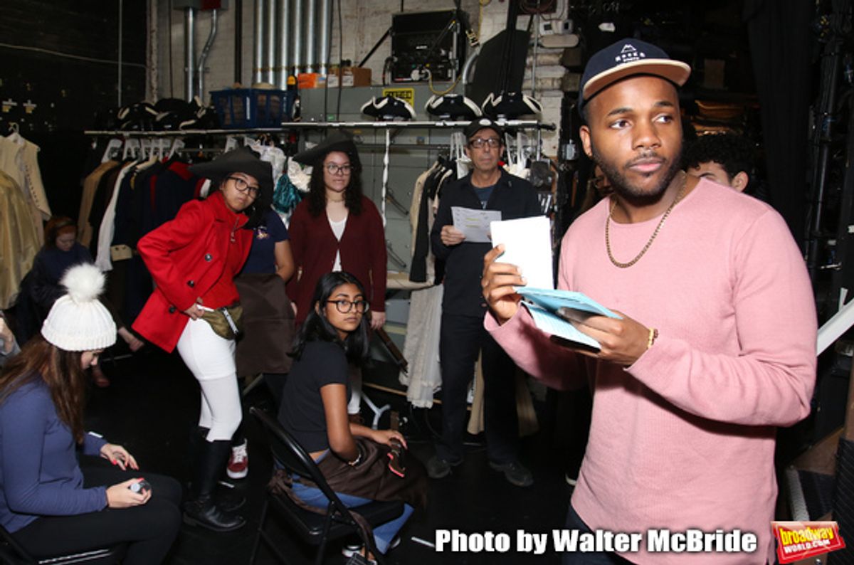 Deon'te Goodman with student performers at 