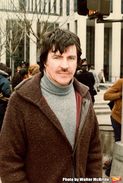 Alan Bates walking on Fifth Avenue in New York City. April 1980. Photo