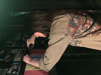 Morgan DeTogne adjusting television monitors backstage. Photo