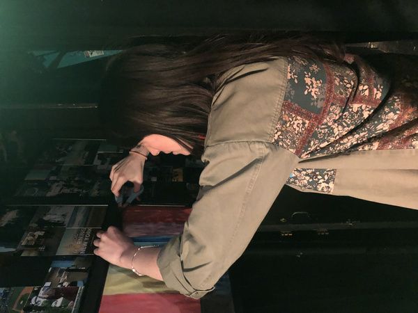 Morgan DeTogne adjusting television monitors backstage. Photo