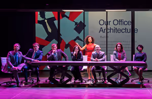 Christy Lockhart (Sydney Morton, standing) knows how to deliver a persuasive Power Point in The Secret of My Success, Paramount Theatre’s world premiere musical about corporate culture, mistaken identity and making your own way in life, based on the 1987 hit film starring Michael J. Fox. Her co workers are played by (from left) George Keating, Jake Morrissy, Brandon Dahlquist, Dara Cameron, Jonathan Schwart, Madison Kauffman and Alexis J. Roston. Performances are February 12-March 29, 2020 at Paramount Theatre, 23 E. Galena Blvd. in Aurora. Tickets: paramountaurora.com or (630) 896-6666. Photo by Liz Lauren @ BroadwayWorld Christy Lockhart (Sydney Morton, standing) knows how to deliver a persuasive Power Po Photo