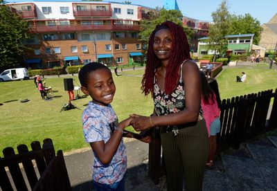 Byker estate residents Damereo and his mum, Lucy Stobbart enjoy live music from their Photo