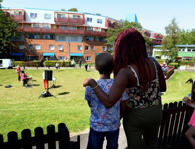 Lucy Stobbart and her son Damereo enjoy live music from their doorstep on the Byker E Photo