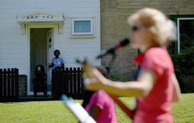 Byker estate residents Lucy Stobbart and her son Damereo enjoy live music from their  Photo