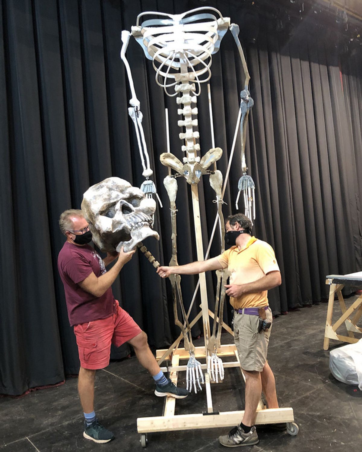 SUNY Cortland Scenic Designer Scott Holdredge and Technical Director Simone Scalici inspect “Jolene”, a giant skeleton puppet. at 