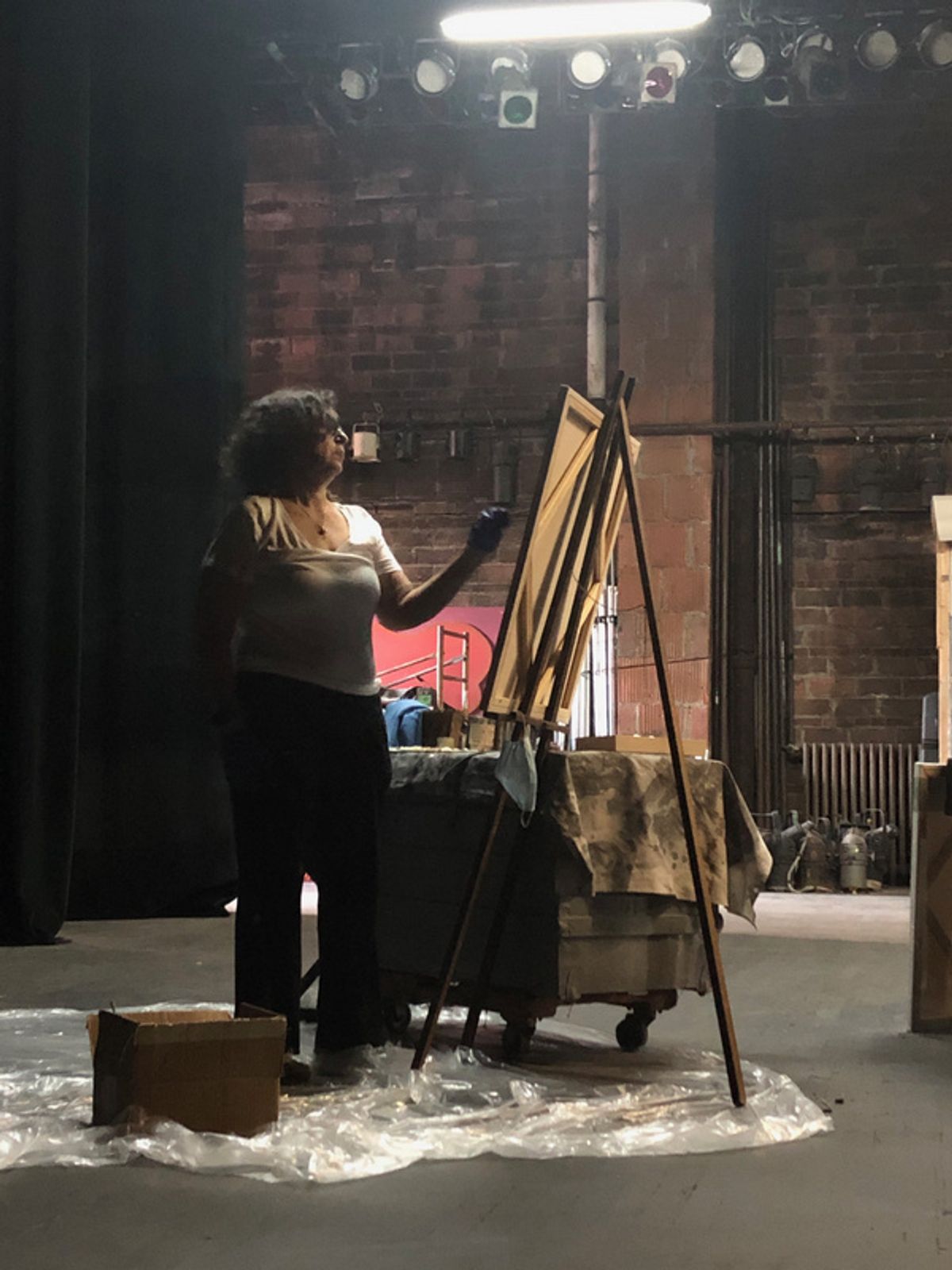 The artist Cara London, painting on the stage of the empty Park Theatre. at See the Newly Restored Park Theatre in Union City