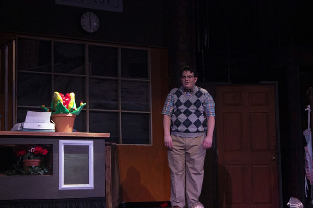 Seymour (Isaac Wesley Wilson) and Audrey II in the Arizona Broadway Theatre production of Little Shop of Horrors at 