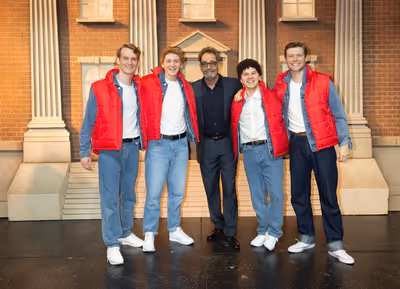 Huey Lewis with the male ensemble Photo