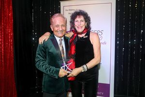 John Sefakis presenting to Sue Samuels Photo