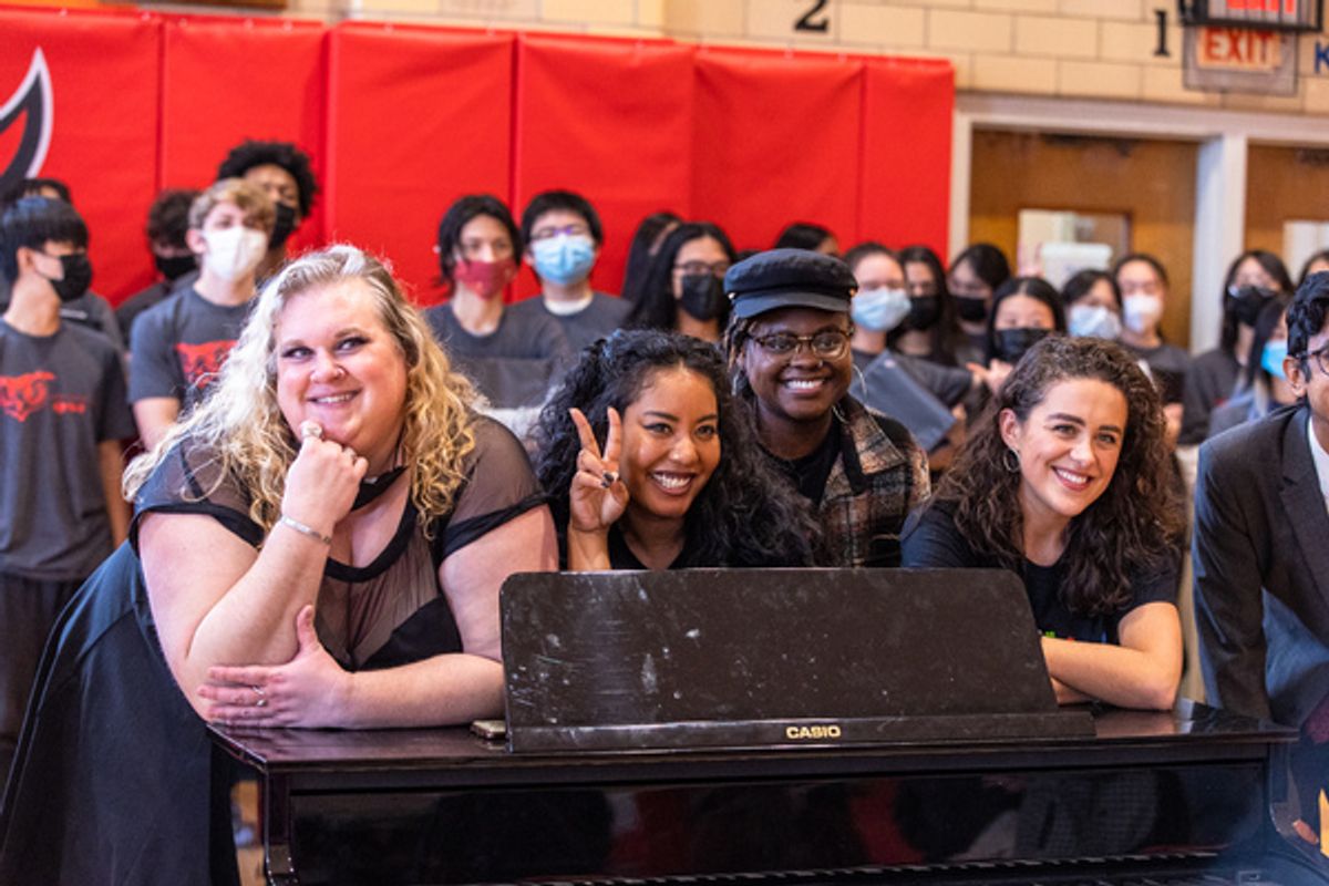 Julia Schade (SIX Musical Director/Conductor/Keyboard), Nicole Kyoung-Mi Lambert (SIX cast member), Keirsten Nicole Hodgens (SIX cast member), Hana Stewart (SIX cast member) at the piano that SIX donated to the school at 