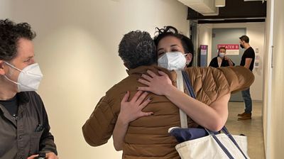 Alexandra Silber and Steven Skybell embrace while Mike Shapiro looks on.  Photo