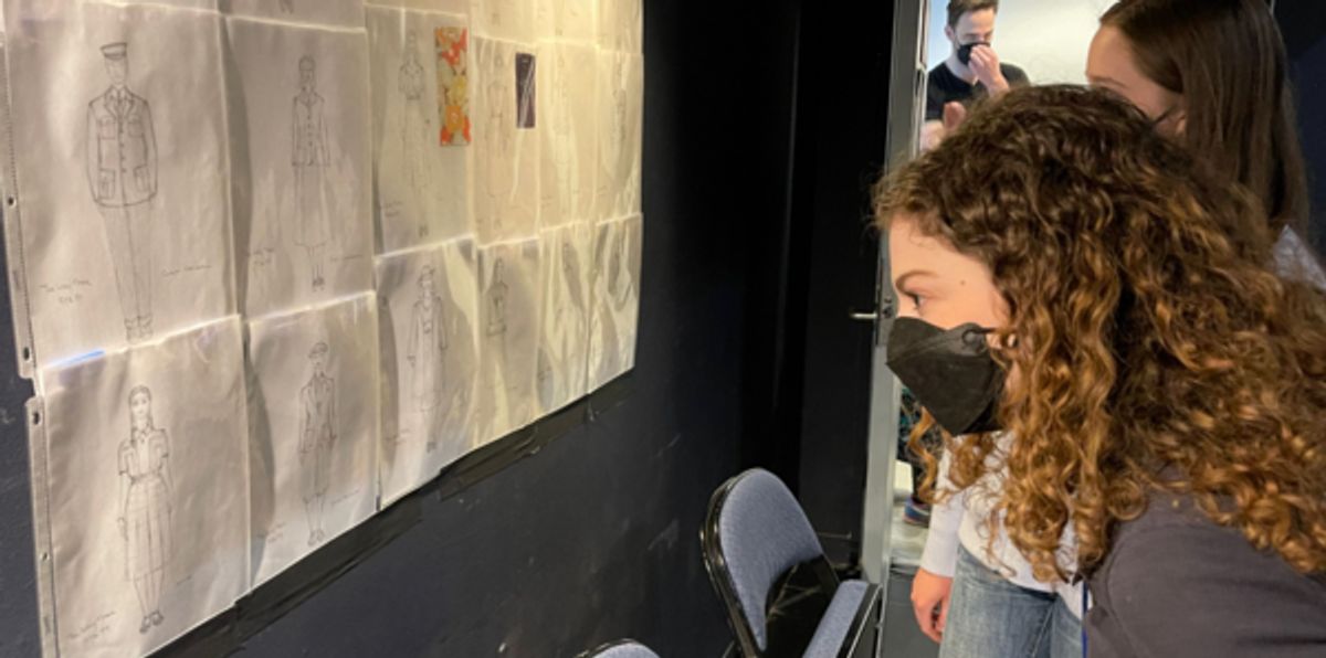 Skye Allisa Friedman looks at costume design sketches by David Burdick and scenic designs by Daniel Ettinger.  at 