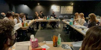 The cast listens as Steven Skybell reads a personal letter from his father.  Photo
