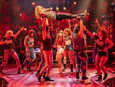 Josh Scholl (center) plays Stacee Jaxx in Rock of Ages Photo