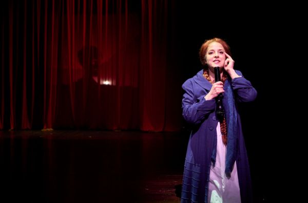 A Radio Announcer (actor, Betsy Mugavero*) gives a play-by-play on the recent happeni Photo