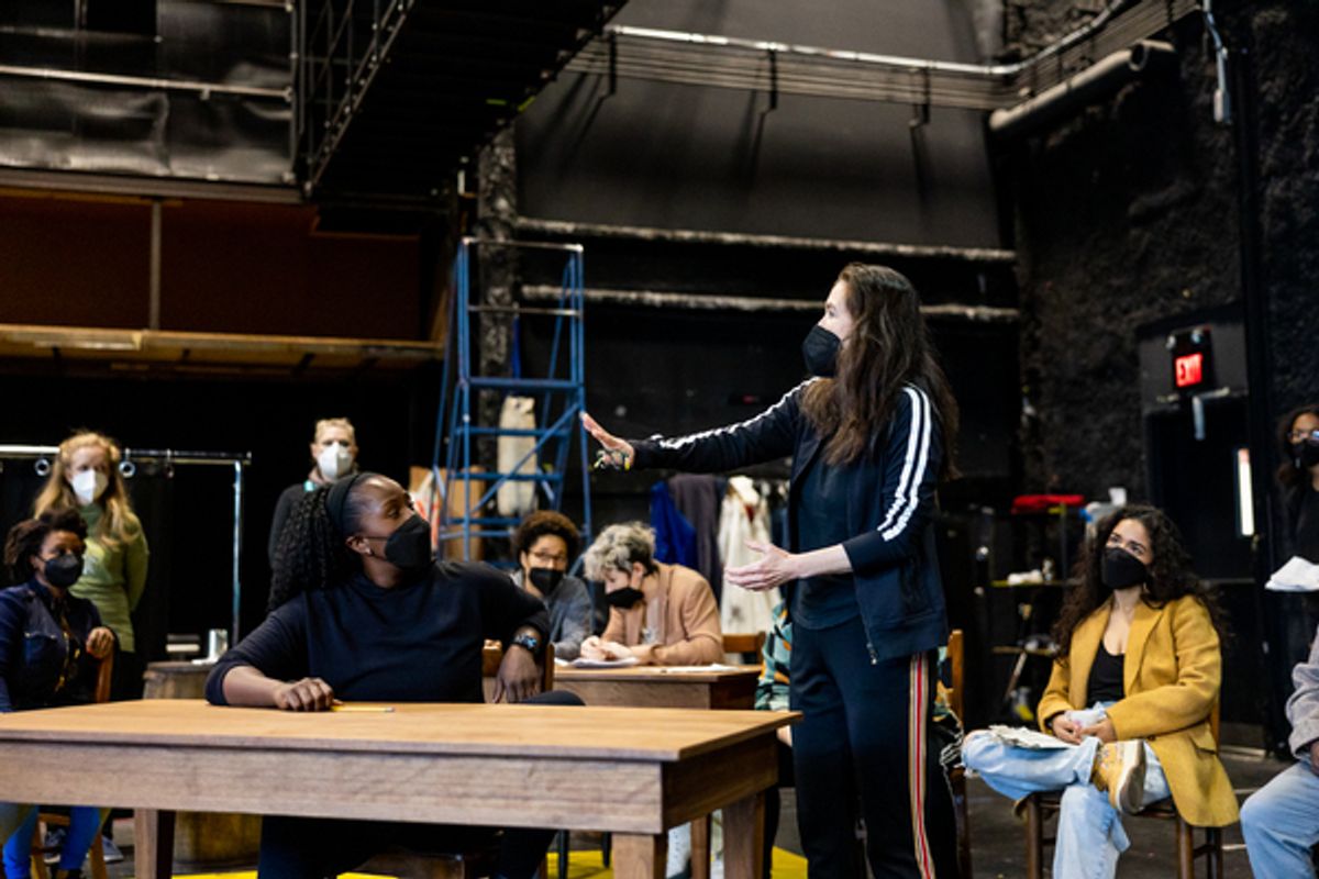 Diane Paulus (standing) with company members  at 
