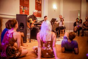 Music directed by Valev Laube, and performed by Valev Laube (violin), Charlie Rauh, a Photo