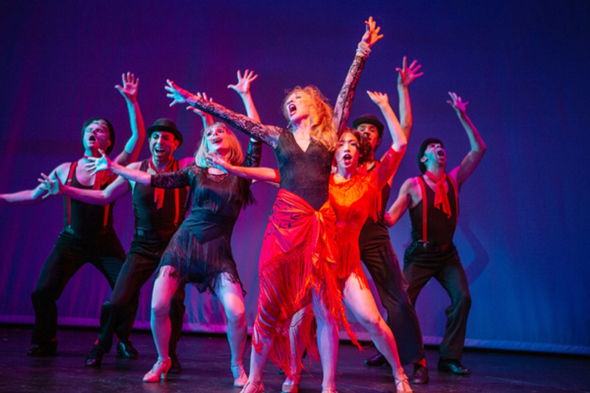 Phyllis Rogers Stone (Maureen McVerry*, center) reckons with life’s choices through The Story of Lucy and Jessie, accompanied by (L-R) Cameron La Brie, Anthony Maglio, Jill Slyter, Ann Warque, Chachi Delgado, and M. Javi Harnly. at 