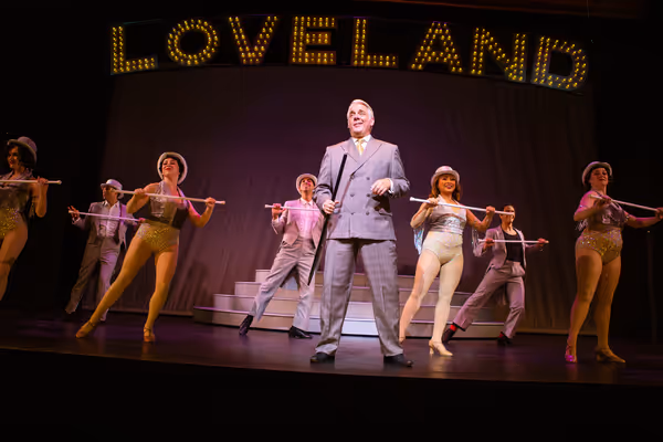 Benjamin Stone (Chris Vettel*, center) reevaluates his priorities during Live, Laugh, Photo