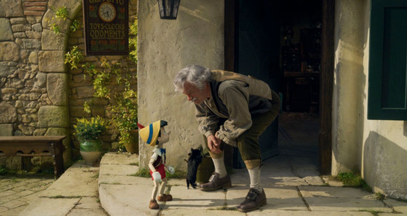 Pinocchio (voiced by Benjamin Evan Ainsworth), Figaro, and Tom Hanks as Geppetto in Disneys live-action PINOCCHIO